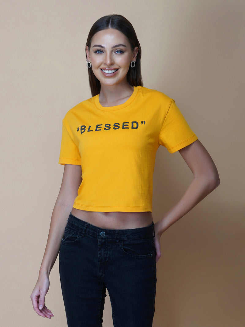 This women's t-shirt features a vibrant yellow color, making it perfect for adding a pop of brightness to any outfit. The T-shirt is made from a soft, comfortable fabric that is perfect for everyday wear. The design features a classic round neckline and short sleeves, making it ideal for warmer weather.  The front of the t-shirt features a stylish quotation in bold black letters, adding a touch of personality to the garment. 