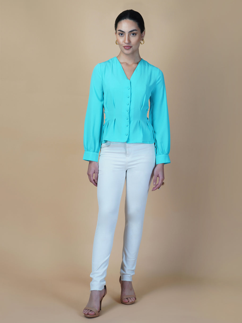 Turquoise color waist pleated women's top with full sleeves is a stylish and fashionable choice for women who want to add some color and texture to their wardrobe. Turquoise is a vibrant and eye-catching color that can help you stand out in a crowd, while the waist pleats add a unique and flattering touch to the design.