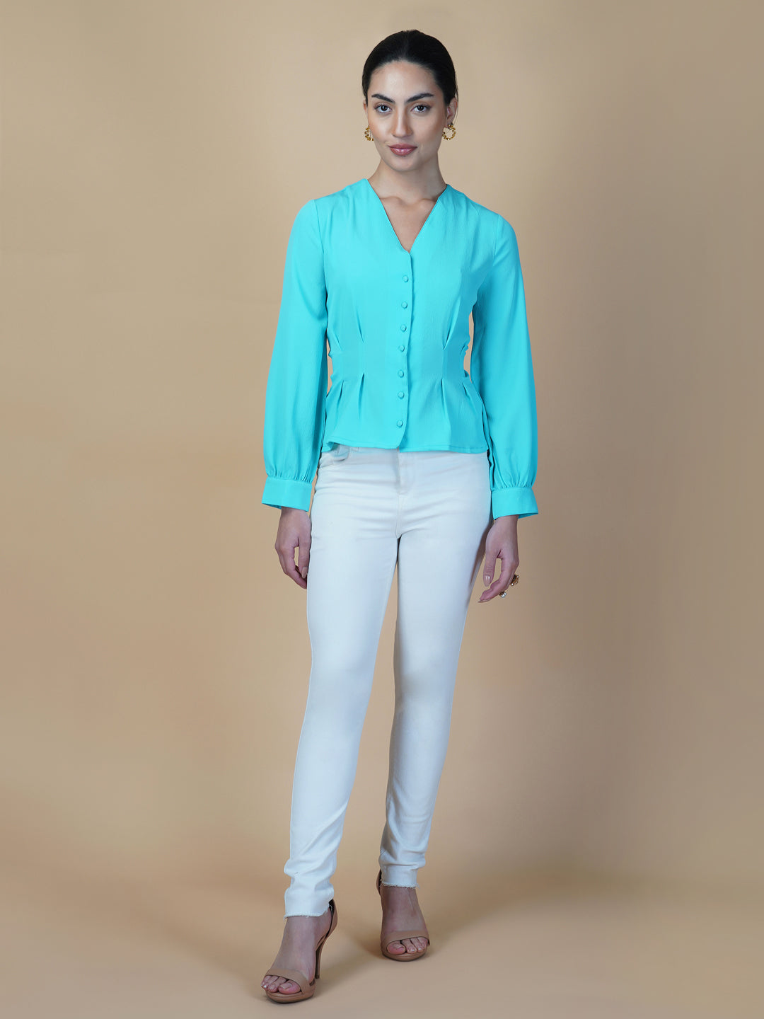 Turquoise color waist pleated women's top with full sleeves is a stylish and fashionable choice for women who want to add some color and texture to their wardrobe. Turquoise is a vibrant and eye-catching color that can help you stand out in a crowd, while the waist pleats add a unique and flattering touch to the design.