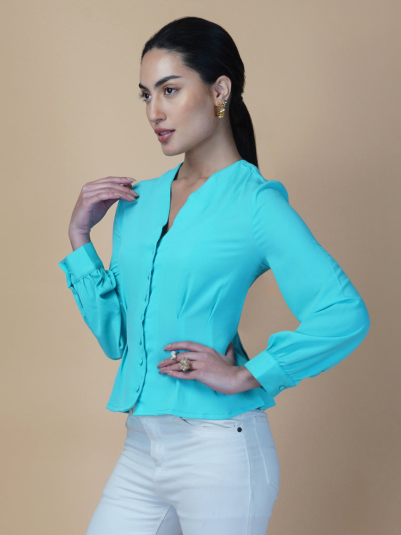 Turquoise color waist pleated women's top with full sleeves is a stylish and fashionable choice for women who want to add some color and texture to their wardrobe. Turquoise is a vibrant and eye-catching color that can help you stand out in a crowd, while the waist pleats add a unique and flattering touch to the design.