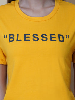 This women's t-shirt features a vibrant yellow color, making it perfect for adding a pop of brightness to any outfit. The T-shirt is made from a soft, comfortable fabric that is perfect for everyday wear. The design features a classic round neckline and short sleeves, making it ideal for warmer weather.  The front of the t-shirt features a stylish quotation in bold black letters, adding a touch of personality to the garment. 