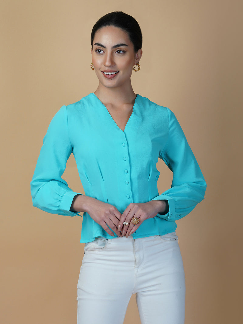 Turquoise color waist pleated women's top with full sleeves is a stylish and fashionable choice for women who want to add some color and texture to their wardrobe. Turquoise is a vibrant and eye-catching color that can help you stand out in a crowd, while the waist pleats add a unique and flattering touch to the design.