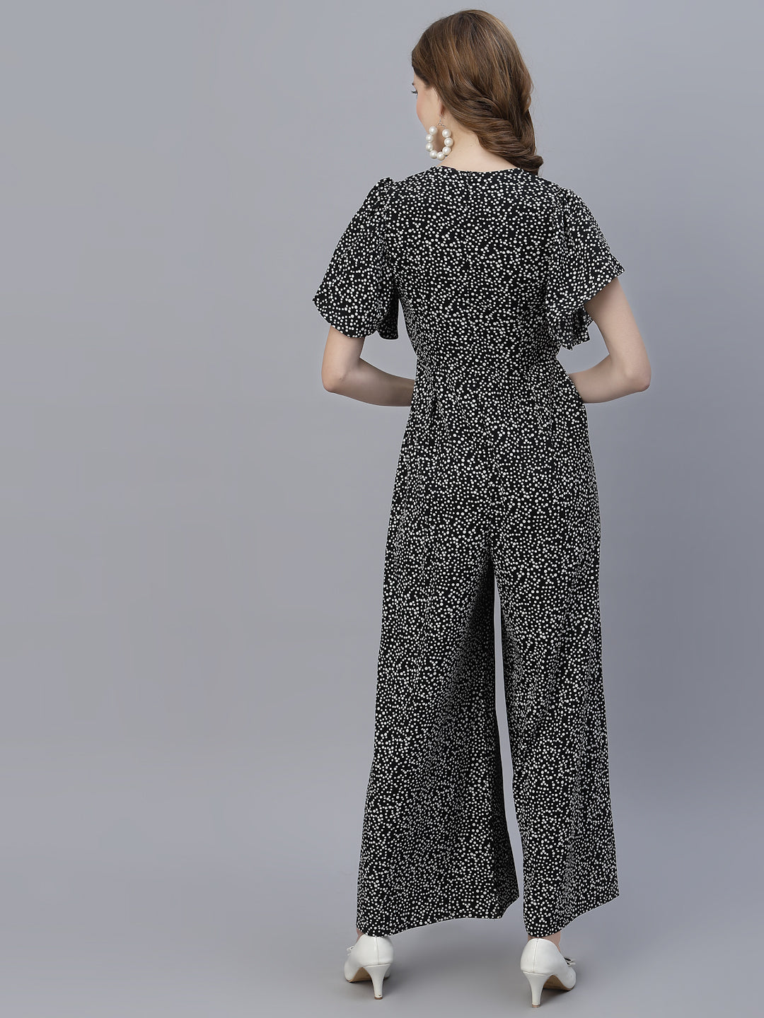 The Black Dot Printed Fit and Flare Jumpsuit for women is a stylish and versatile outfit that is perfect for any occasion. This women jumpsuit is designed to fit and flatter the female form, with a fitted waist that cinches in to create a flattering silhouette. The black and white polka dot print adds a playful touch to this chic jumpsuit for women, making it perfect for both casual and formal events.