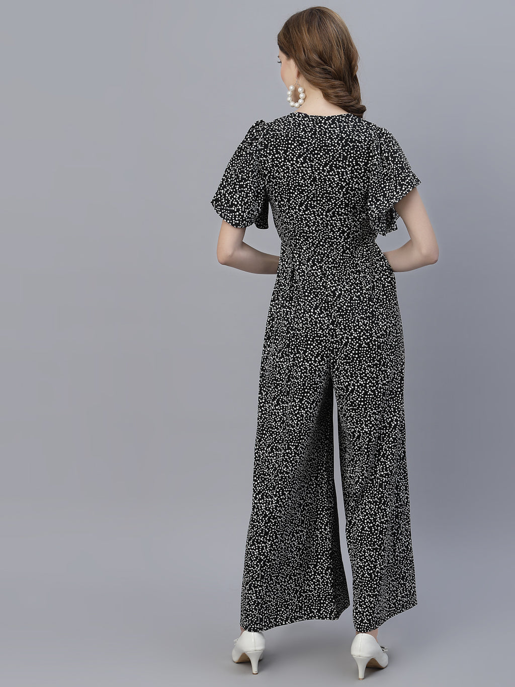 The Black Dot Printed Fit and Flare Jumpsuit for women is a stylish and versatile outfit that is perfect for any occasion. This women jumpsuit is designed to fit and flatter the female form, with a fitted waist that cinches in to create a flattering silhouette. The black and white polka dot print adds a playful touch to this chic jumpsuit for women, making it perfect for both casual and formal events.