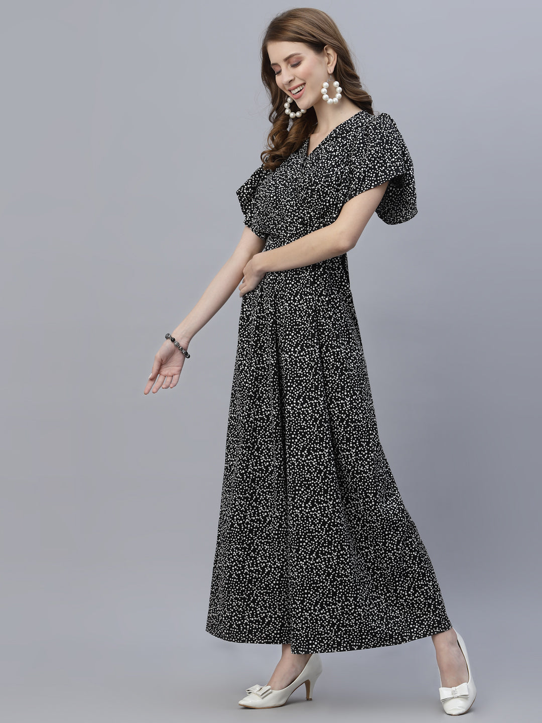 The Black Dot Printed Fit and Flare Jumpsuit for women is a stylish and versatile outfit that is perfect for any occasion. This women jumpsuit is designed to fit and flatter the female form, with a fitted waist that cinches in to create a flattering silhouette. The black and white polka dot print adds a playful touch to this chic jumpsuit for women, making it perfect for both casual and formal events.