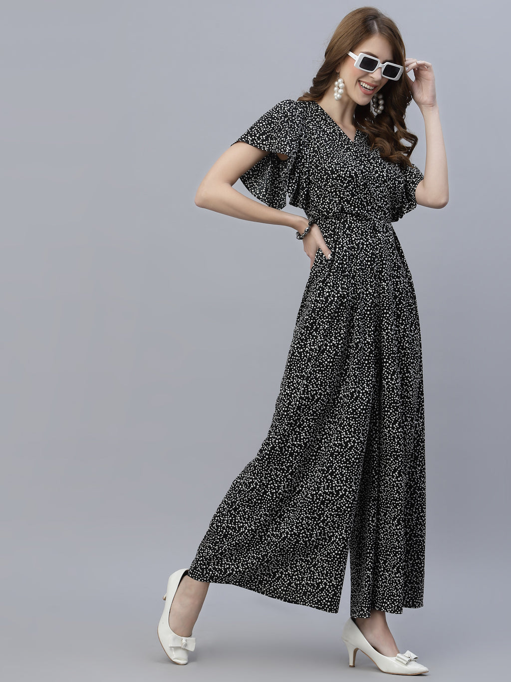 The Black Dot Printed Fit and Flare Jumpsuit for women is a stylish and versatile outfit that is perfect for any occasion. This women jumpsuit is designed to fit and flatter the female form, with a fitted waist that cinches in to create a flattering silhouette. The black and white polka dot print adds a playful touch to this chic jumpsuit for women, making it perfect for both casual and formal events.